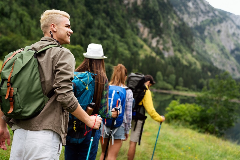 People hiking. Group of happy hiker friends trekking as part of healthy lifestyle outdoors activity