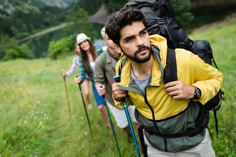 People hiking. Group of happy hiker friends trekking as part of healthy lifestyle outdoors activity
