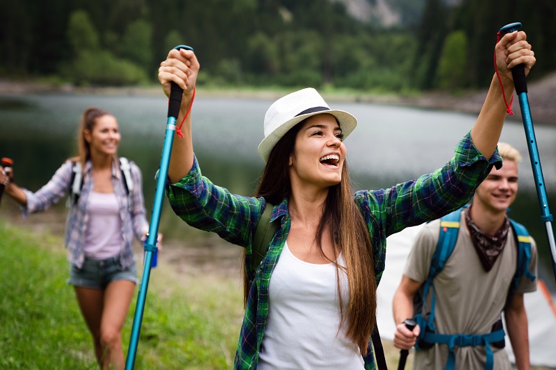 People hiking. Group of happy hiker friends trekking as part of healthy lifestyle outdoors activity