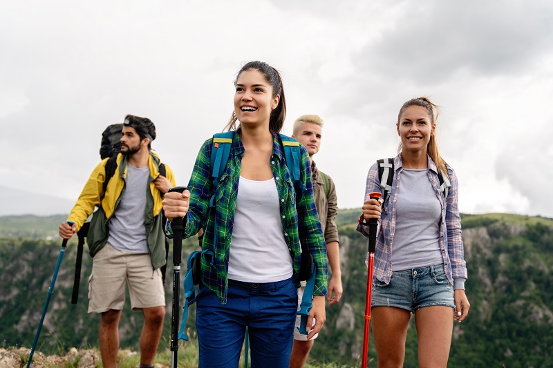 People hiking. Group of happy hiker friends trekking as part of healthy lifestyle outdoors activity